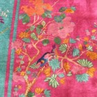 Chinese Art Deco rugs - rug with a turquoise band and hot pink field that includes flowers and birds - via Atticmag