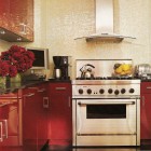 red lacquer cabinets with a white mosaic backsplash in a modern apartment kitchen - Elle Decor via Atticmag