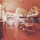 traditional Tuscan villa kitchen with fireplace and antique sink - via Atticmag