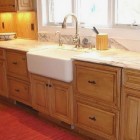 bumped out Rohl fireclay farm sink with Kohler Vinnata faucet on calacatta d'oro counter - Atticmag