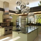 house with mid century style modern kitchen with bubble chandelier and window walls - Luxist via Atticmag