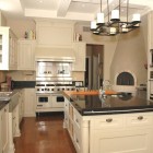 wood burning oven kitchen - black and white kitchen with beehive pizza oven - Scott Yetman via Aticmag