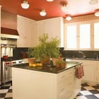 red kitchen accents - black and white kitchen with red ceiling by Joe Nye via Atticmag