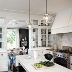 marble subway tile - range wall of a black and white kitchen with marble subway tiles by Jessica Helgerson - via Atticmag