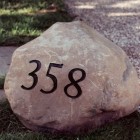 large rock with black metal house numbers as the address - Martha Stewart Living via Atticmag