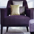 purple chair with accent pillows in coordinating fabric scheme