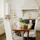 kitchen seating - white kitchen with black Lacanche range and slipcovered dining chairs - Mary Evelyn Interiors via Atticmag
