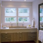 double vanity bathrooms - bathroom vanity with a single oversized concrete trough sink and two faucets - hutker architects via Atticmag