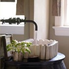 antique marble sink on black lacquer console table by Melanie Pounds - House Beautiful via Atticmag