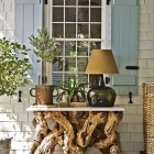 entrance decor - gnarled wood table and lamp front porch by Steven Gambrel via Atticmag