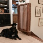 stairway gates - custom salvage wood and copper piping bifold stairway gate - Atticmag