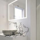 bathroom task lighting - contemporary white Danish bathroom with illuminated frame mirror over the sink - Norm.Architects.Copenhagen via Atticmag