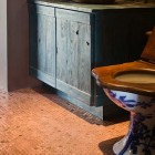 penny mosaic tile - rustic bathroom with penny covered floor by Red Rock Contractors via Atticmag