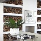 firewood storage - modern living room with firewood shelves flanking the hearth - style files via atticmag