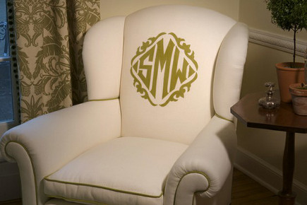monogrammed easy chairs - white upholstered chair with green monogram and contrast piping - Brenda Kelly Kramer via Atticmag