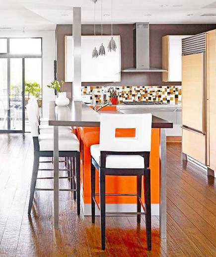 orange home decor on a kitchen island in mid-century modern style kitchen – bhg via atticmag