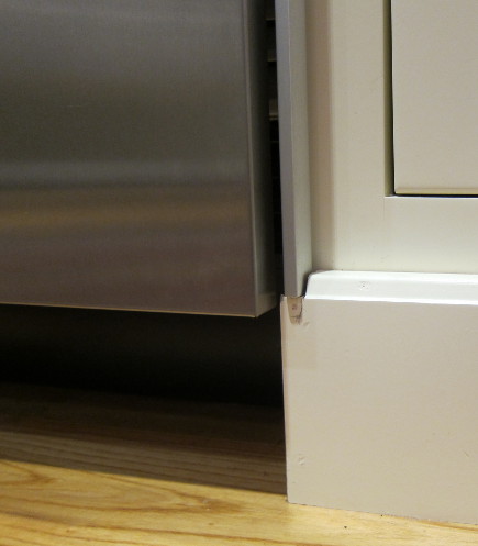 built in refrigerator - cabinet baseboard cut to accommodate bottom of refrigerator frame - atticmag