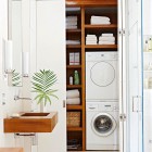laundry room features - master bathroom laundry closet with stacked European front loaders - bh & g via Atticmag