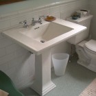 seafoam guest bath - Memoirs Stately pedestal sink and Ann Sacks green penny round floor tiles - Atticmag